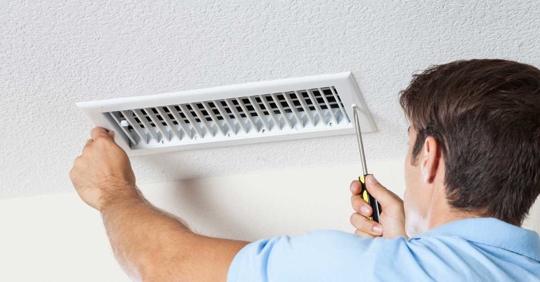 man checking air vents